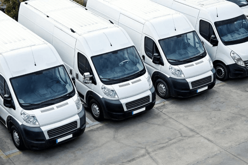 Fleet of white service vans parked side by side